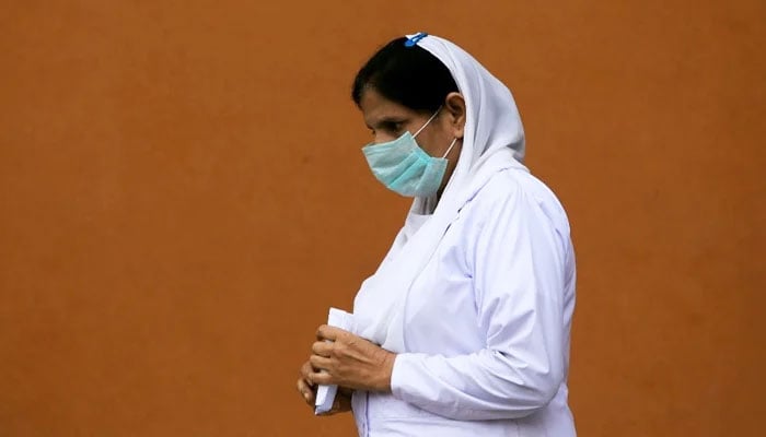 A nurse wears a face mask as she walks at the premises of the Lady Reading Hospital in Peshawar, Pakistan March 4, 2020. — Reuters/File