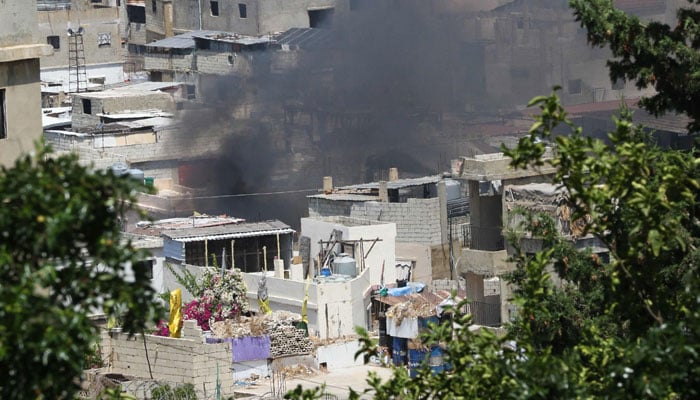 Smoke billows during clashes between the Fatah movement and Islamists inside the Ain el-Helweh Palestinian refugee camp in the southern coastal city of Sidon on July 31, 2023. — AFP