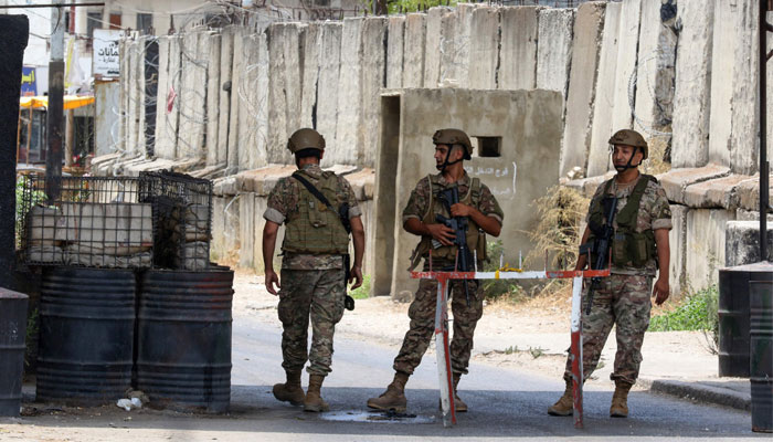 Lebanese soldiers stand guard at one of the entrances to the Ain el-Helweh Palestinian refugee camp in the southern coastal city of Sidon on July 31, 2023, during ongoing clashes between the Fatah movement and Islamists inside the camp. — AFP