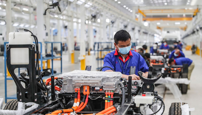 An employee working on a new energy vehicle assembly line at a BYD factory in Huaian in Chinas eastern Jiangsu province, July 6, 2020. — AFP