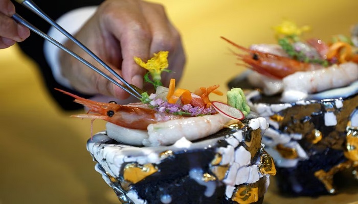 Kazuyuki Tanioka, the owner of Japanese cuisine Toya restaurant, prepares a sashimi dish, during an interview with Reuters, in Beijing, China July 25, 2023.—Reuters/File