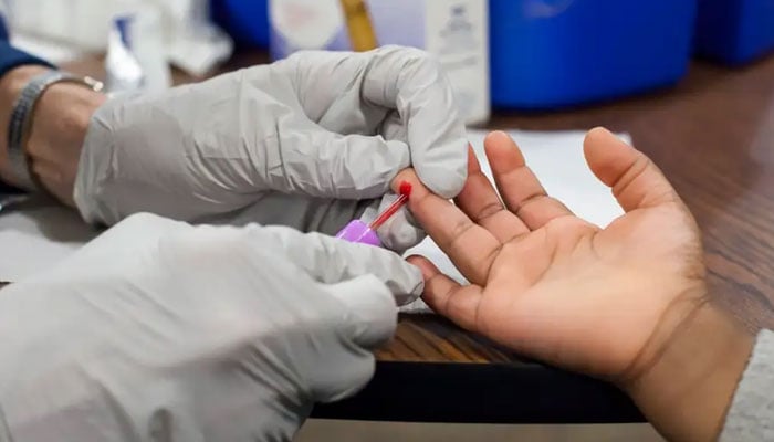 A blood sample is being taken from a 3-year-old girl in Flint, Michigan, to test for exposure to lead. newscientist.com