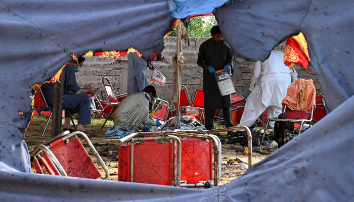 Police officials examine the site of a bomb blast in Bajaur district of Khyber-Pakhtunkhwa province on July 31, 2023. — AFP