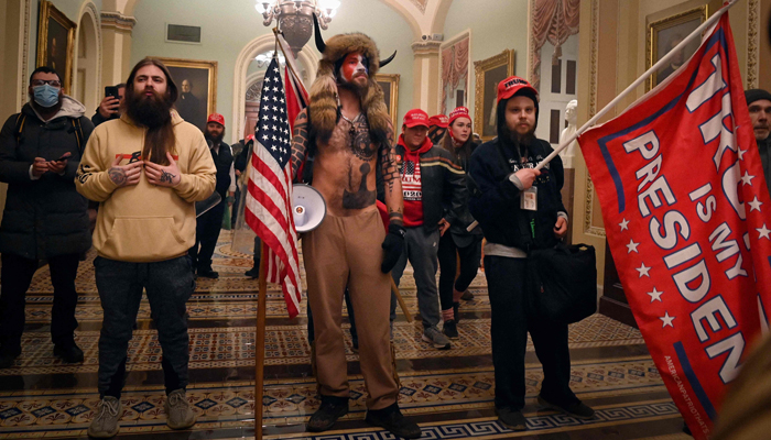 Supporters of former US President Donald Trump, including members of the QAnon conspiracy group Jake Angeli, aka Yellowstone Wolf (C), enter the US Capitol on January 6, 2021, in Washington, DC.—  AFP