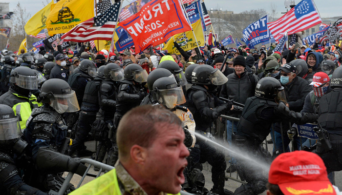 Trump supporters clash with police and security forces as people try to storm the US Capitol in Washington DC on January 6, 2021. — AFP