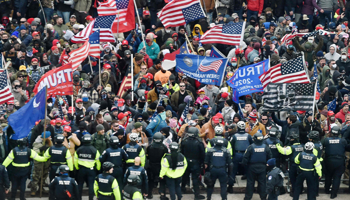 Trump supporters clash with police and security forces as they storm the US Capitol in Washington, DC on January 6, 2021. — AFP