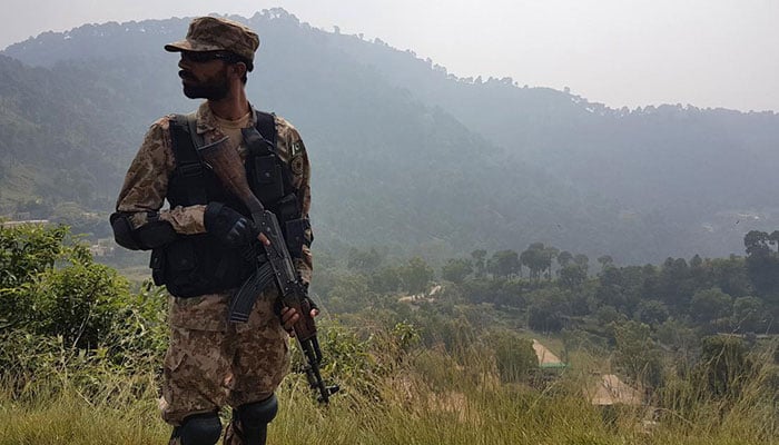 A Pakistani soldier keeps guard at a village near the Line of Control. — AFP