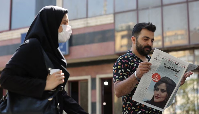 A man views a newspaper with a cover picture of Mahsa Amini, a woman who died after being arrested by the Islamic republics morality police in Tehran, Iran September 18, 2022. — Reuters