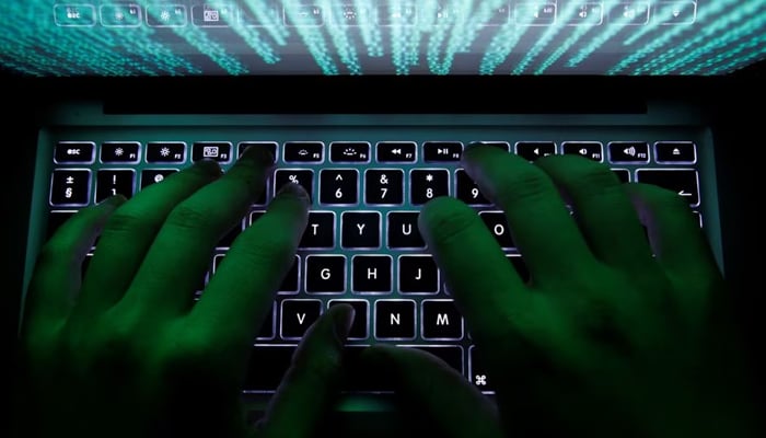 A man types on a computer keyboard in Warsaw on February 28, 2013. — Reuters