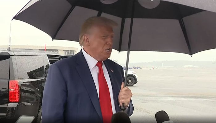 Former US president Donald Trump speaks to the media while standing on the airport tarmac before leaving Washington. Twitter video.