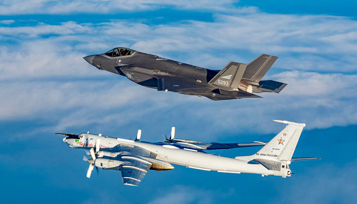 In this March 2020 handout image from the Norwegian Armed Forces a Norwegian F-35 fighter jet intercepts a Russian Tupolev TU-142 (Bear-J)near Norwegian air space along the Norwegian / Russian border. — AFP