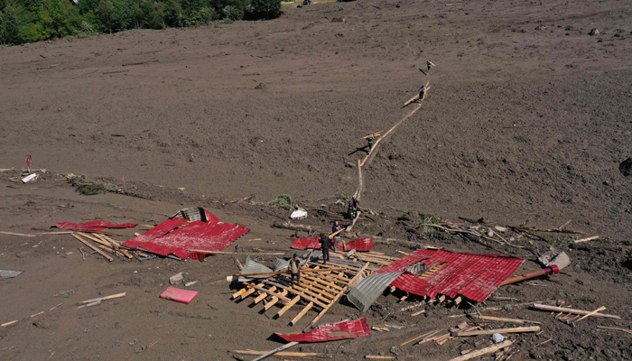 This aerial photo taken with a drone shows rescue personnel working at the site of a landslide in the western Georgian region of Racha on August 4, 2023. — AFP