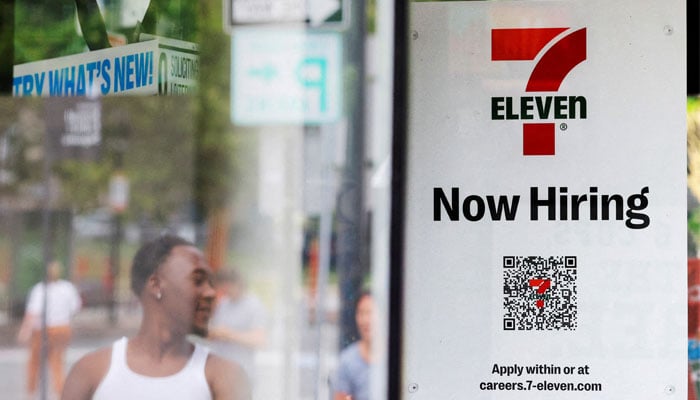 A 7-Eleven convenience store has a sign in the window reading Now Hiring in Cambridge, Massachusetts, US, July 8, 2022. — Reuters
