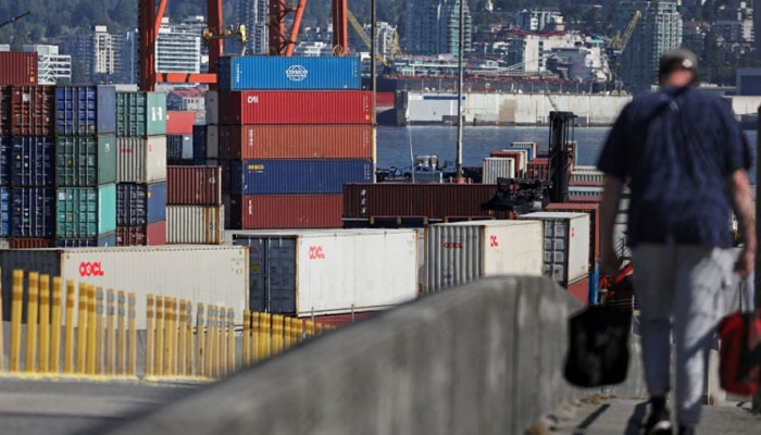 A worker walks to the Port of Vancouver as International Longshore and Warehouse Union (ILWU) union members returned to clear a backlog of containers and bulk cargo from a 13-day strike in Vancouver, British Columbia July 20, 2023. — Reuters