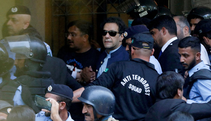 Security officers escort former prime minister Imran Khan as he appeared in Islamabad High Court, Islamabad, May 12, 2023. — Reuters