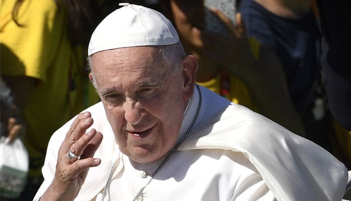 Pope Francis waves from the popemobile as he arrives for a meeting with volunteers of the World Young Day (WYD) dance in Alges, 10km away from Lisbon, on August 6, 2023. — AFP