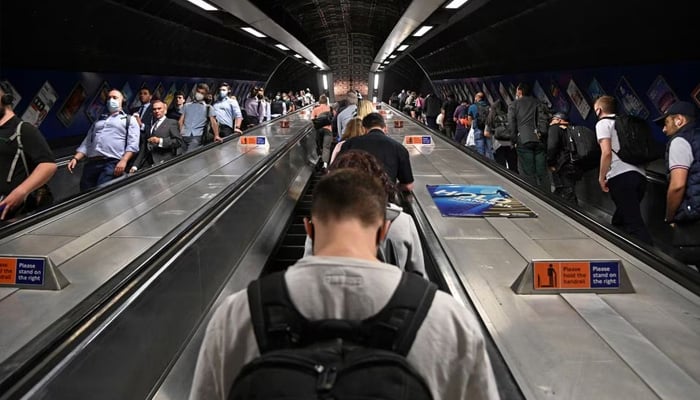 Workers travel through London Bridge rail and underground station during the morning rush hour in London, Britain, September 8, 2021. — Reuters