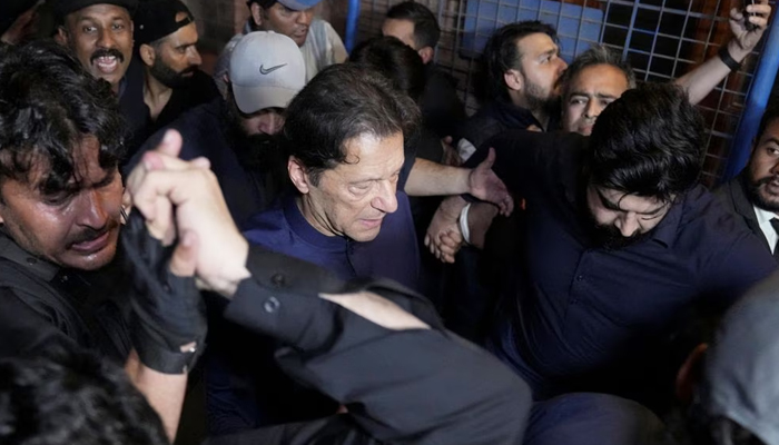 Former prime minister Imran Khan along with his supporters walks as he leaves the district High Court in Lahore, February 20, 2023. — Reuters