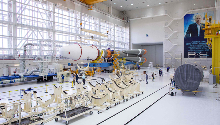This photo taken on August 7, 2023, shows technicians finishing assembling a Soyuz 2.1b rocket carrying the Luna-25 lander at the Vostochny cosmodrome, in the Amur region. — AFP