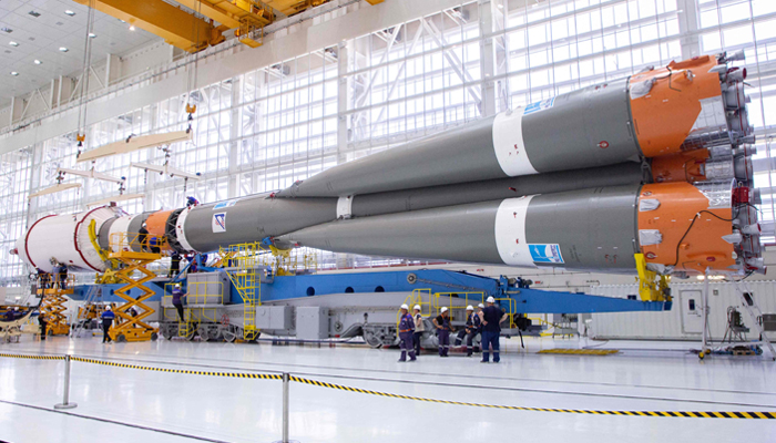 This photo taken on August 7, 2023, shows technicians finishing assembling a Soyuz 2.1b rocket carrying the Luna-25 lander at the Vostochny cosmodrome in the Amur region. — AFP