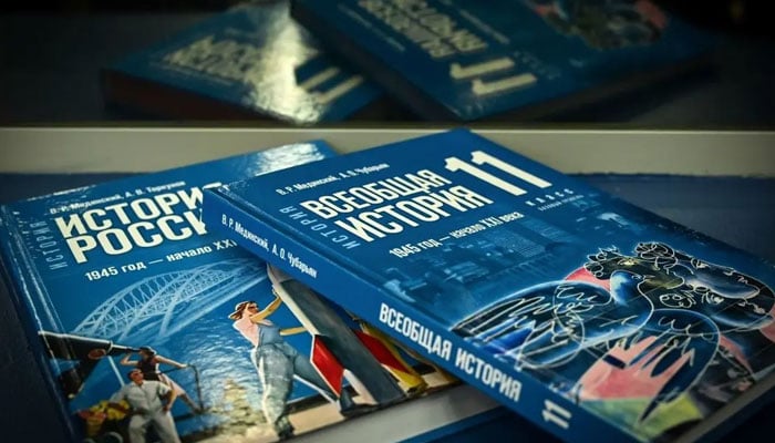 New schoolbooks for high school students on general world history and Russian history, mentioning the the countrys ongoing military action in Ukraine and the annexation of Crimea in 2014, are seen during its presentation in Moscow on August 7, 2023. AFP