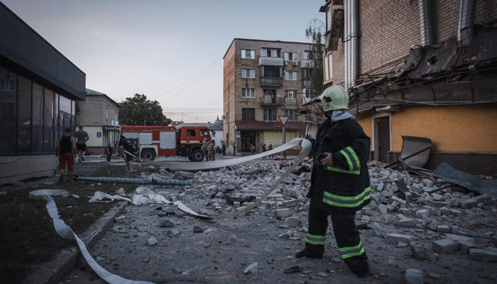 This photograph taken on August 7, 2023, shows rescuers working outside a damaged residential building following Russian missile strikes in Pokrovsk, Donetsk region, amid the Russian-Ukraine war. — AFP