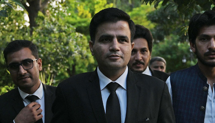 Naeem Haider Panjutha (C), spokesperson to PTI Chairman Imran Khan on legal affairs, arrives for a media briefing in Islamabad on August 7, 2023. — AFP