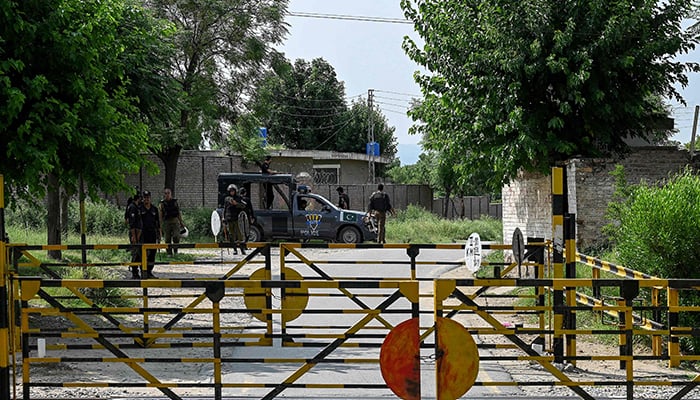 Policemen stand guard at the Attock prison post where former prime minister Imran Khan is being held for three years in Attock on August 6, 2023. — AFP