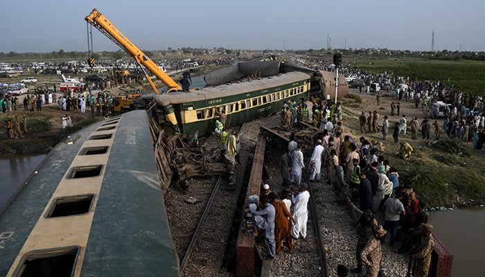 A crane arrives to clear the tracks after a train derailed in Sarhari town in district Sanghar, Pakistan August 6, 2023. — Reuters