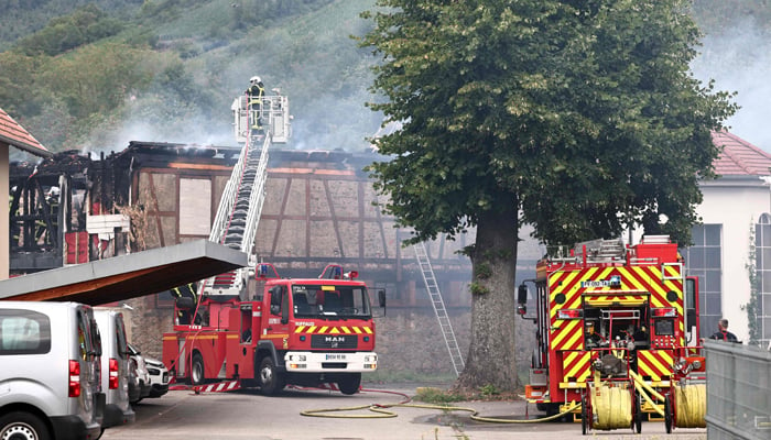 Firefighters work to extinguish a fire which erupted at a home for disabled people in Wintzenheim near Colmar, eastern France, on August 9, 2023. — AFP