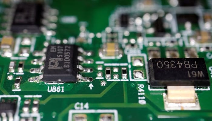 Semiconductor chips are seen on a printed circuit board in this illustration picture taken February 17, 2023. — Reuters