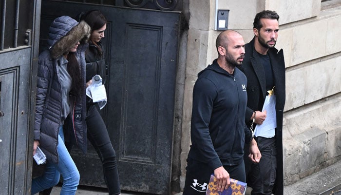 British-US former professional kickboxer and controversial influencer Andrew Tate (3rd L) and Tristan Tate (R) together with two Romanian complices women (L and 2nd L) exit a court in Bucharest, Romania, on January 10, 2023. — AFP/File