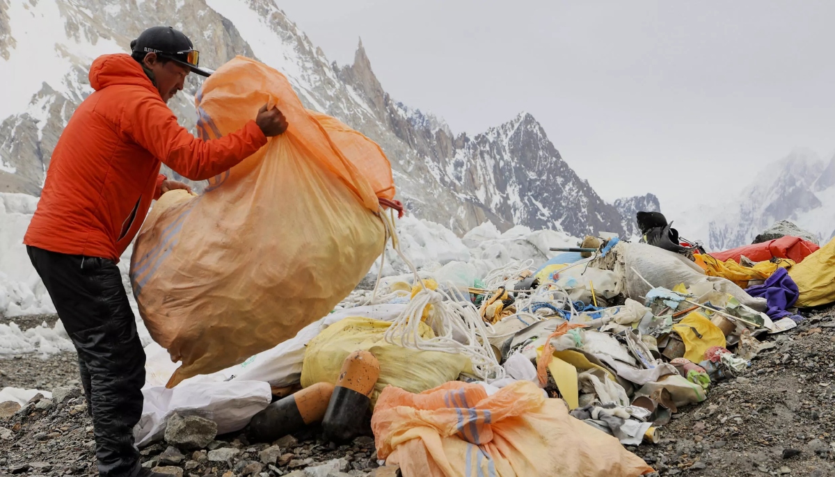 A member of Sajid Ali Sadparas team cleans up the litter. — AFP/File