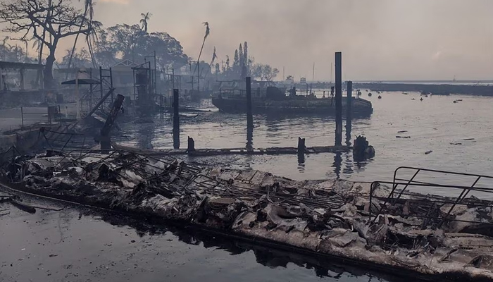 A charred boat lies in the scorched waterfront after wildfires fanned by the winds of a distant hurricane devastated Mauis city of Lahaina, Hawaii, US August 9, 2023. — Reuters