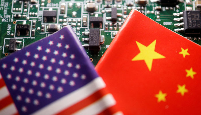 The flags of China and the US are displayed on a printed circuit board with semiconductor chips, in this illustration picture. — Reuters