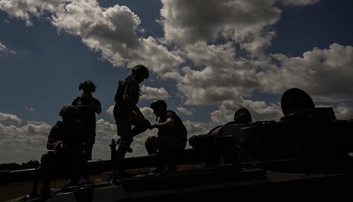 Ukrainian troops can be seen preparing to depart as they are getting onto a battle tank in Ukraine in this picture released on July 26, 2023. — Instagram/zelenskiy_official