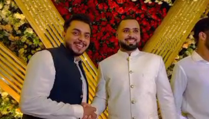 Faheem Ashraf can be seen shaking hand at his engagement ceremony in this till taken from a video. — Reporter