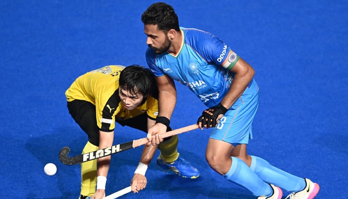 Malaysia´s Khaliq Hamirin (L) and India´s captain Harmanpreet Singh eye the ball during the Asian Champions Trophy 2023 hockey tournament final match between India and Malaysia at the Mayor Radhakrishnan Stadium in Chennai on August 12, 2023. — AFP