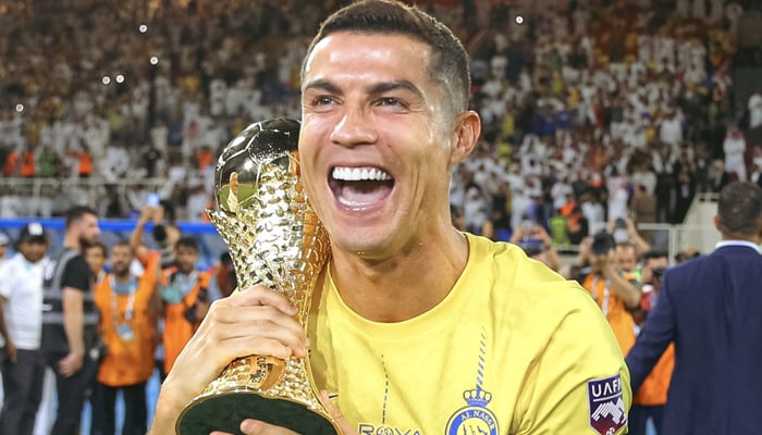 Al-Nassrs Cristiano Ronaldo celebrates with the trophy after winning the Arab Club Champions Cup final. — Twitter/@Cristiano