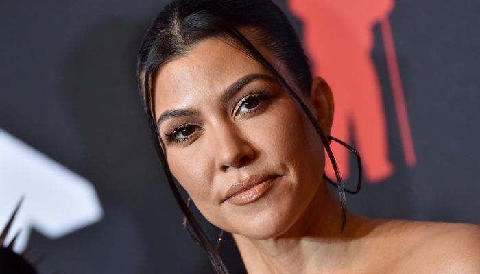 Kourtney Kardashian dons a fitted red dress while out with her daughter