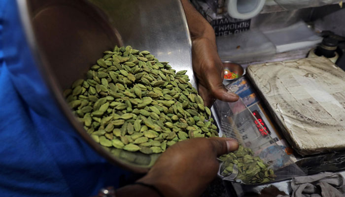 A shopkeeper packs cardamom for a customer in a market area in the old quarters of Delhi, India, July 9, 2019. —Reuters/file