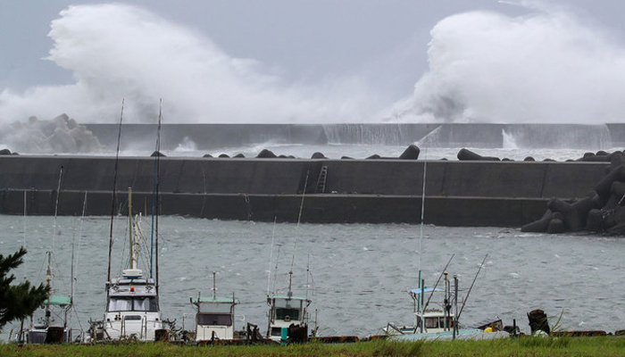 High waves crash onto the embankment as Typhoon Lan approaches Japans main island of Honshu, at the town of Kiho, Mie prefecture, on August 14, 2023. — AFP