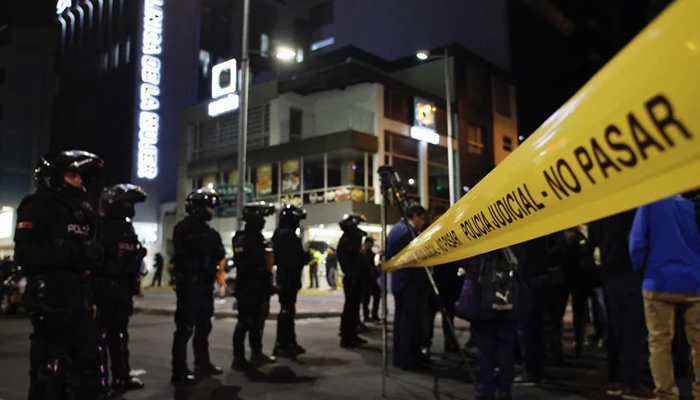 Police stand guard outside the hospital where presidential candidate Fernando Villavicencio was taken after being shot in Quito on August 9, 2023. — AFP