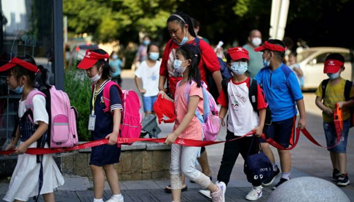 Children in Wuhan queue for Covid-19 testing.—Reuters/File