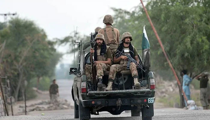 Armed security forces personnel ride on an army van. —AFP/File
