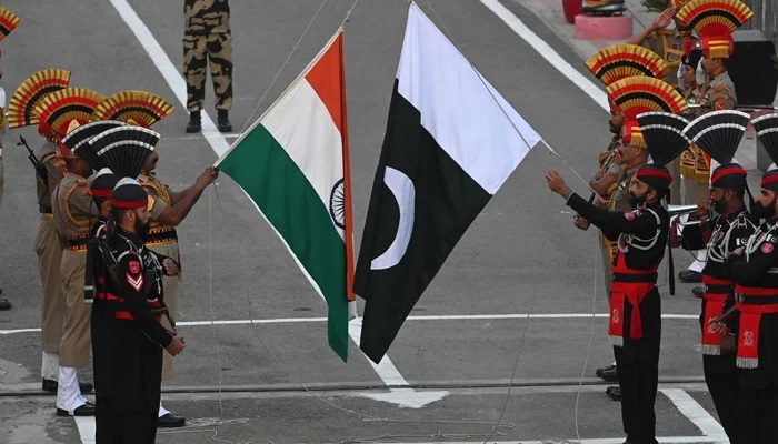 Pakistani Rangers (in black) and Indian BSF soldiers take part in the Beating the Retreat ceremony on the eve of Pakistans Independence Day celebrations at the Wagah border post on August 13, 2023. — AFP