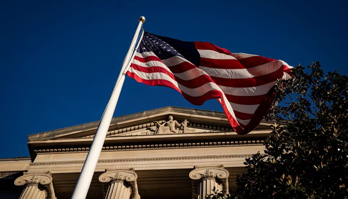 An American flag waves outside the U.S. Department of Justice Building in Washington, U.S., December 15, 2020. — AFP