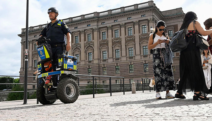 A police officer on a Segway patrol at Sweden´s parliament Riksdagen as the terror threat level in Sweden was raised to four on a five-point scale on August 17, 2023, following recent Koran burnings.—AFP