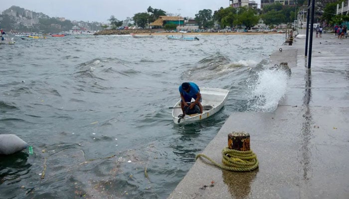 A man moors his boat in Acapulco, Guerrero State, Mexico, on Aug. 16, 2023, following the passage of Tropical Storm Hilary. AFP