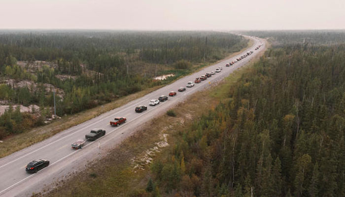 Yellowknife residents leave the city on Highway 3, the only highway in or out of the community, after an evacuation order was given due to the proximity of wildfires in Yellowknife, Northwest Territories, on August 16, 2023. Reuters